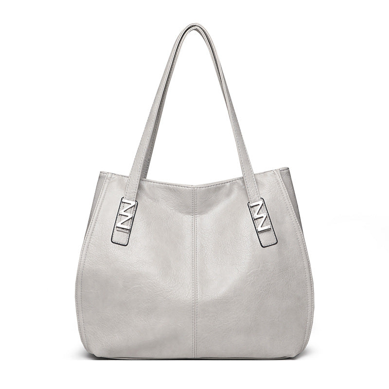Bolso de mano retro-chic, de lujo sutil y gran capacidad.