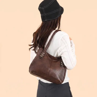 Bolso de mano retro-chic, de lujo sutil y gran capacidad.
