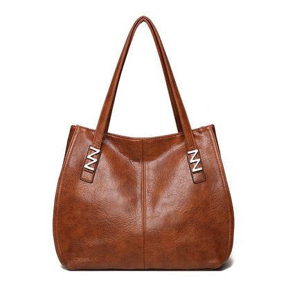 Bolso de mano retro-chic, de lujo sutil y gran capacidad.
