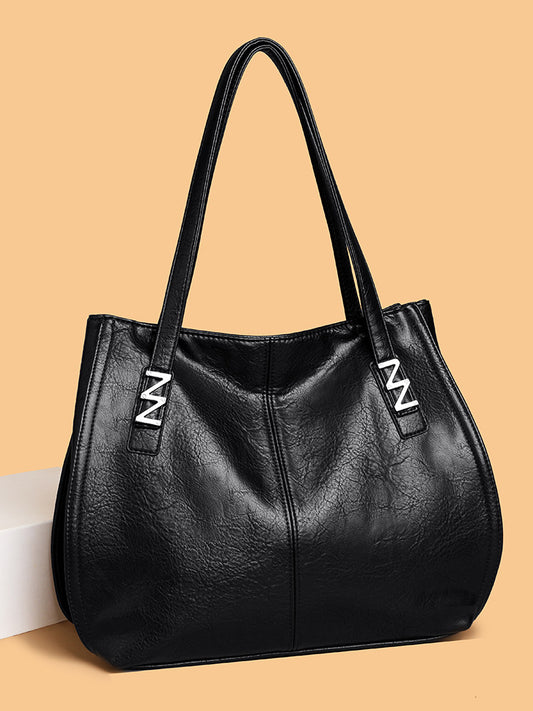 Bolso de mano retro-chic, de lujo sutil y gran capacidad.