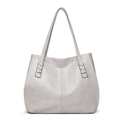 Bolso de mano retro-chic, de lujo sutil y gran capacidad.