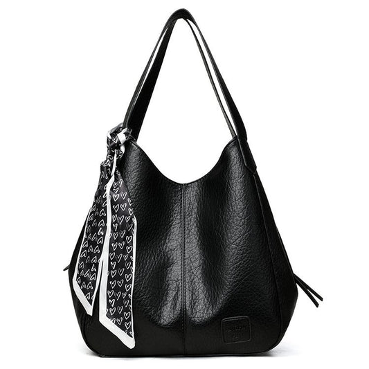 Bolso tote vintage de piel suave con múltiples compartimentos.