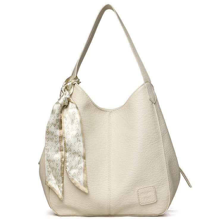 Bolso tote vintage de piel suave con múltiples compartimentos.